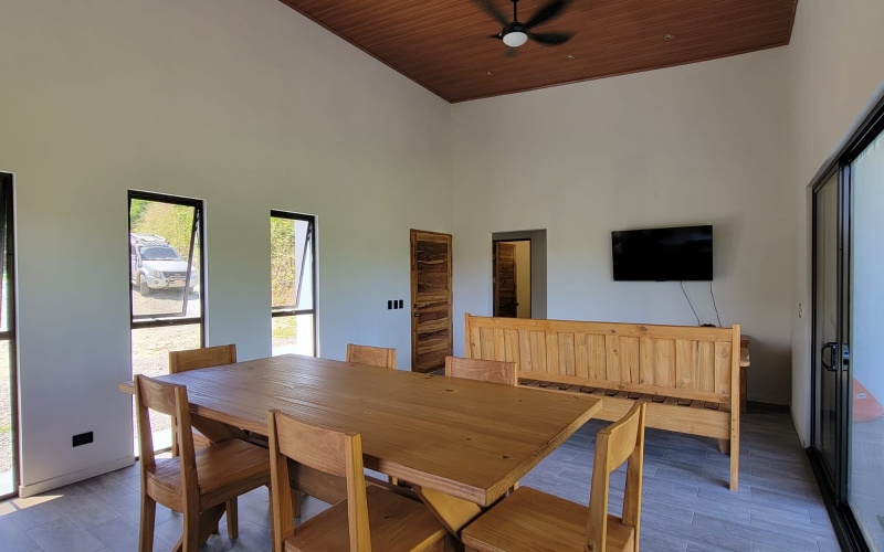 Large Dining table and living room with TV